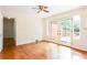 Sunny bedroom featuring hardwood floors, ceiling fan, and French doors to the deck at 2227 Leafmore Drive, Decatur, GA 30033