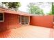 Outdoor deck with a red brick house, wood flooring, and privacy fence at 2227 Leafmore Drive, Decatur, GA 30033