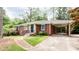 Charming brick home with a covered carport, offering a blend of classic style and practical convenience at 2227 Leafmore Drive, Decatur, GA 30033