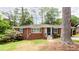 Charming brick home with landscaped front yard, blue shutters, and stone entry at 2227 Leafmore Drive, Decatur, GA 30033