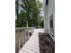 A backyard white deck with a walkway overlooking the lush backyard at 3285 Rollingbrook Way, Duluth, GA 30096