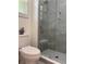 Modern bathroom featuring gray marble tiled walls, a glass shower door, and a built-in bench at 3285 Rollingbrook Way, Duluth, GA 30096
