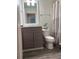 Modern bathroom with updated vanity, hardware and fixtures, plus tiled floor and neutral color palette at 3285 Rollingbrook Way, Duluth, GA 30096