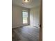 This bedroom features hardwood flooring and a bright window overlooking the front yard at 3285 Rollingbrook Way, Duluth, GA 30096