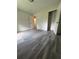 Bedroom featuring modern gray plank flooring, a white door and trim and white walls at 3285 Rollingbrook Way, Duluth, GA 30096
