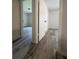 Hallway featuring modern gray plank flooring and white doors with black hardware at 3285 Rollingbrook Way, Duluth, GA 30096