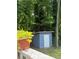 A blue storage shed in the backyard near lush green trees at 3285 Rollingbrook Way, Duluth, GA 30096