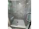 Bathroom shower featuring gray tile surround, a shower head, and a glass enclosure at 3285 Rollingbrook Way, Duluth, GA 30096