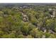 Lovely aerial view of a property nestled among lush green trees in a beautiful wooded neighborhood at 4152 Barberry Ne Dr, Roswell, GA 30075