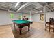 Basement area with a pool table and drop ceiling perfect for entertaining guests at 4152 Barberry Ne Dr, Roswell, GA 30075