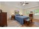 Primary bedroom with hardwood flooring, tray ceiling, natural light, and comfortable furnishings at 4152 Barberry Ne Dr, Roswell, GA 30075
