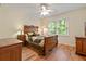 Well-appointed bedroom features hardwood flooring, natural light, a ceiling fan and quality furnishings at 4152 Barberry Ne Dr, Roswell, GA 30075