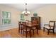 Dining room features hardwood floors, wainscoting, and a chandelier at 4152 Barberry Ne Dr, Roswell, GA 30075