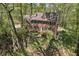 Charming brick home on a hillside, surrounded by mature trees and greenery at 4152 Barberry Ne Dr, Roswell, GA 30075
