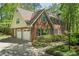 Traditional brick home boasts a two-car garage, dormer windows, and a well-manicured lawn at 4152 Barberry Ne Dr, Roswell, GA 30075