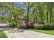 Beautiful front exterior view of a brick home with mature landscaping and a long driveway at 4152 Barberry Ne Dr, Roswell, GA 30075