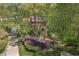 Exterior view of home nestled among trees with lovely landscaping and driveway at 4152 Barberry Ne Dr, Roswell, GA 30075