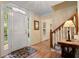 Inviting foyer features hardwood floors, paneled front door and staircase with a view to the front at 4152 Barberry Ne Dr, Roswell, GA 30075