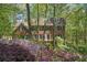 Charming brick home with a lush, landscaped front yard and colorful azaleas in a beautiful, wooded setting at 4152 Barberry Ne Dr, Roswell, GA 30075