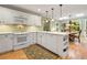 Bright eat-in kitchen with white cabinetry, stainless appliances, and a breakfast area with lots of windows at 4152 Barberry Ne Dr, Roswell, GA 30075