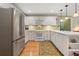 Bright kitchen features white cabinets, stainless steel appliances, and hardwood floors at 4152 Barberry Ne Dr, Roswell, GA 30075