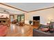 Spacious living room with hardwood floors, fireplace, wood trim, many windows and natural light at 4152 Barberry Ne Dr, Roswell, GA 30075