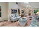 Bright sunroom featuring skylights, terracotta tiles, and casual wicker furniture with vibrant floral patterns at 4152 Barberry Ne Dr, Roswell, GA 30075