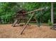 Community playground with a wooden playset, slide, swings, and a picnic table at 4152 Barberry Ne Dr, Roswell, GA 30075