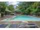 Community pool with lounge chairs, umbrellas, and a covered pavilion for shade at 4152 Barberry Ne Dr, Roswell, GA 30075