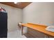 Unfinished basement storage room with a wall mounted craft table and tile flooring at 4152 Barberry Ne Dr, Roswell, GA 30075