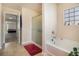 Bright bathroom with a tub, separate shower, and neutral tones, creating a spa-like ambiance at 8484 Glenview St, Douglasville, GA 30134