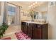 Bathroom featuring double sinks, a large mirror, modern lighting, and ample counter space at 8484 Glenview St, Douglasville, GA 30134