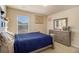 Cozy bedroom with a comfortable bed, dresser, and natural light from the window at 8484 Glenview St, Douglasville, GA 30134