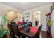 Elegant dining room with hardwood floors, large table, and views into the kitchen and staircase at 8484 Glenview St, Douglasville, GA 30134