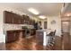Spacious kitchen with dark cabinets, granite countertops, and a breakfast bar with seating at 8484 Glenview St, Douglasville, GA 30134