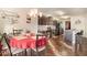 Eat-in kitchen featuring dark cabinets, stainless appliances, granite counters, breakfast bar, and dining area at 8484 Glenview St, Douglasville, GA 30134