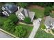 Overhead shot of the home featuring its layout, large yard, driveway with car, and surrounding neighborhood at 1035 Eagles Brooke Dr, Locust Grove, GA 30248