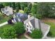 Aerial view showcasing the home's location within a lush, tree-lined suburban neighborhood with well-maintained lawns at 1035 Eagles Brooke Dr, Locust Grove, GA 30248