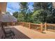 Relaxing back deck with views of trees and the backyard with seating for outdoor enjoyment at 1035 Eagles Brooke Dr, Locust Grove, GA 30248