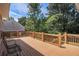 Relax on the spacious wooden deck overlooking the private backyard at 1035 Eagles Brooke Dr, Locust Grove, GA 30248