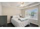 Cozy bedroom offers natural light, a ceiling fan, and dark floors at 1035 Eagles Brooke Dr, Locust Grove, GA 30248