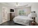 Bright bedroom with hardwood floors, tray ceiling, and attached bathroom at 1035 Eagles Brooke Dr, Locust Grove, GA 30248