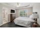 Bedroom with dark wood floors features a large window and ensuite bath at 1035 Eagles Brooke Dr, Locust Grove, GA 30248