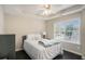 Cozy bedroom with a tray ceiling, large window, and dark wood floors at 1035 Eagles Brooke Dr, Locust Grove, GA 30248