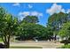 View of the community pool area with lounge chairs and a slide, surrounded by trees and green grass at 1035 Eagles Brooke Dr, Locust Grove, GA 30248