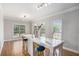 Bright dining room featuring hardwood floors, large windows, and modern table with chairs at 1035 Eagles Brooke Dr, Locust Grove, GA 30248