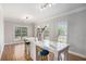 Bright dining area with natural light from three windows, marble countertop island, and hardwood floors at 1035 Eagles Brooke Dr, Locust Grove, GA 30248