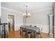 Formal dining area with chandelier, crown molding, hardwood floors, and classic architectural details at 1035 Eagles Brooke Dr, Locust Grove, GA 30248