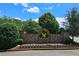 Community entrance sign at Eagle's Brooke neighborhood, framed by lush greenery and colorful flowerbeds at 1035 Eagles Brooke Dr, Locust Grove, GA 30248