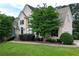 Charming home with a well-maintained lawn, mature trees, and a welcoming facade at 1035 Eagles Brooke Dr, Locust Grove, GA 30248
